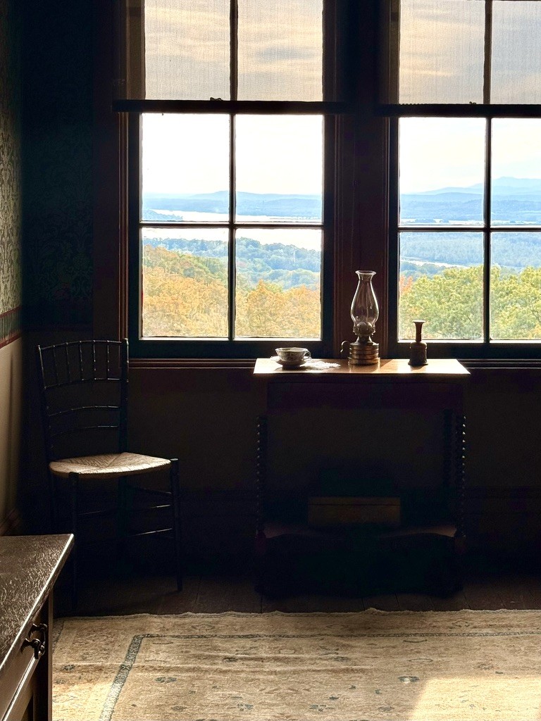 Sunlight through a window overlooking distant hills