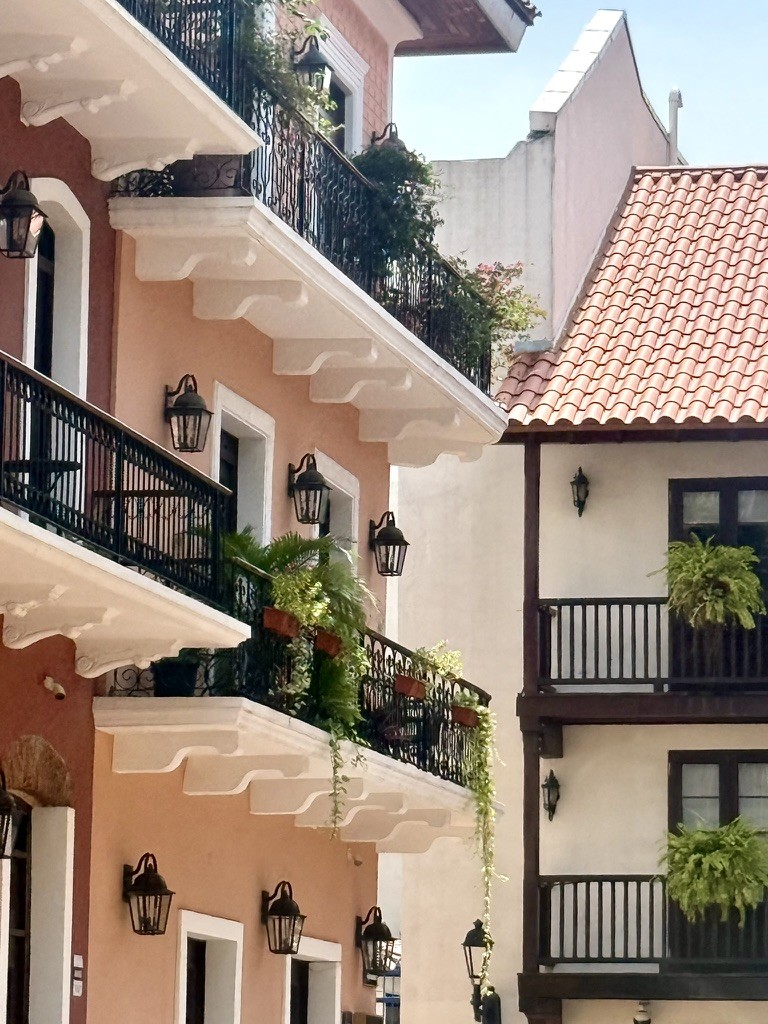 Pink and white buildings with dark wooden balconies