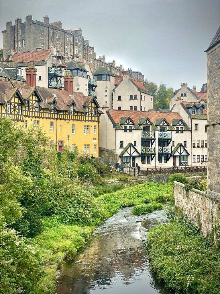 Historic houses and a castle above a winding river